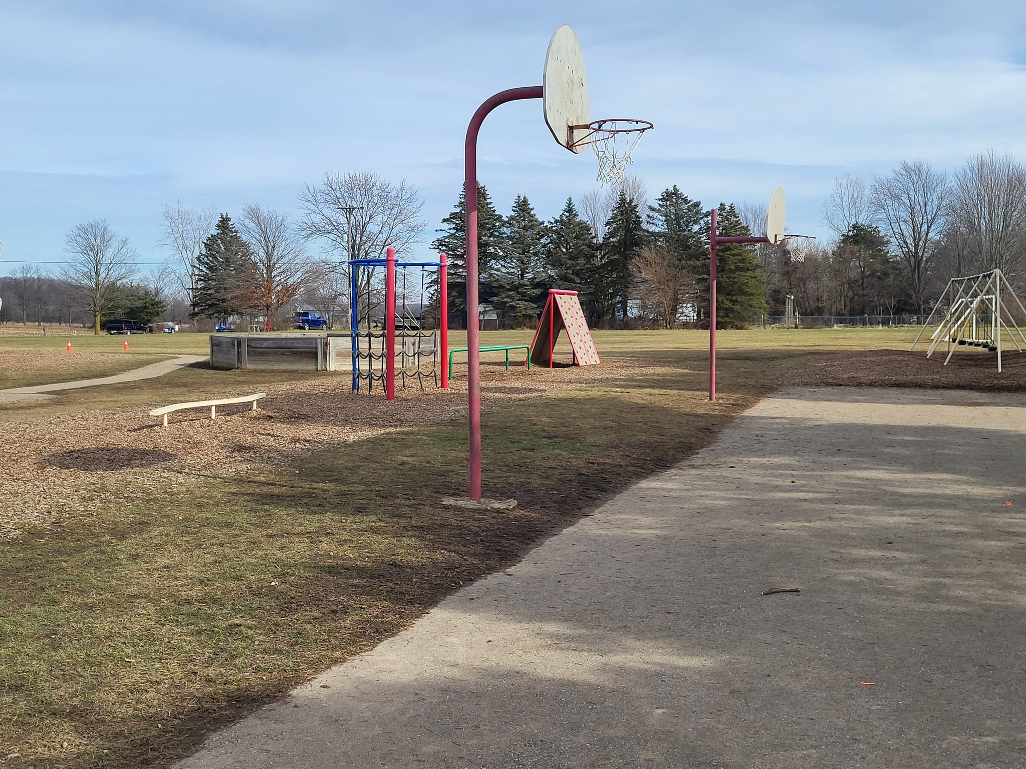 Photo of aging basketball hoop and blacktop